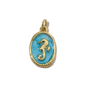 Macro view of gold-plated seahorse pendant with light blue enamel and sparkling finish