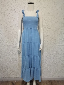 Detail of light blue tiered dress with jacquard texture and ribbon tie straps