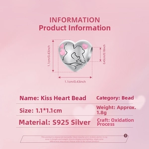Detail view of a 925 sterling silver heart charm with kissing couple and pink enamel