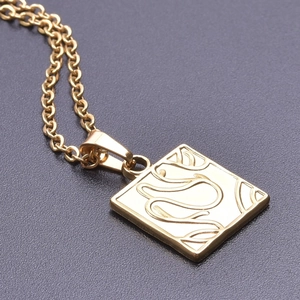 Macro shot of 18k gold plated square pendant with abstract swirl pattern on O-chain