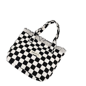 Lace-trimmed checkerboard canvas handbag with black and white grid patterns for women