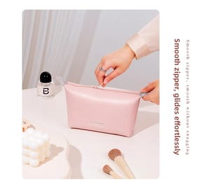 Detail of smooth pink PU cosmetic bag showing premium zipper and soft leather texture