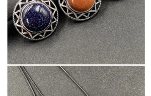 Detailed view of silver starburst pendants with blue and orange gemstones and black cords