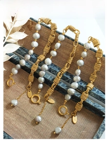 Macro detail of natural gray baroque pearls and gold brass chain with K18 tag