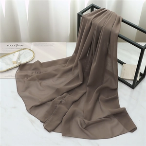 Brown chiffon scarf texture detail shown with premium fashion magazine background