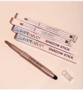 Close-up of dual-ended eyeshadow stick and brush set in elegant rose gold finish