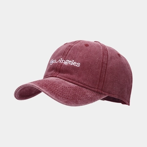 Retro burgundy washed cotton baseball cap with white Los Angeles embroidery at a side view