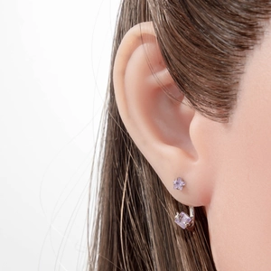 Star and square purple zircon C-shaped earrings worn by a model in a minimalist style