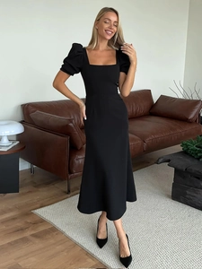 Detail of square neckline and puff sleeves on the elegant black midi dress for women