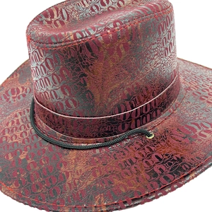 Detail of vintage cowboy hat with burgundy faux crocodile texture and red stitching