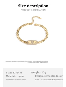 Detail of gold Cuban chain bracelet featuring a rhinestone heart and star reliefs