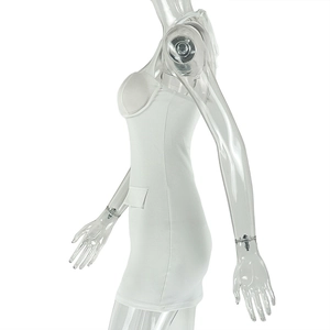 Detail of white mini dress featuring structured cups and side decorative pocket flaps