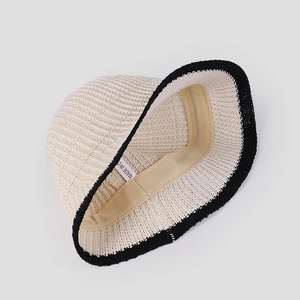 Detail of breathable knitted bucket hat showing inner sweatband and striped texture