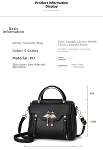 Detailed view of black litchi pattern PU leather handbag with swan metal buckle