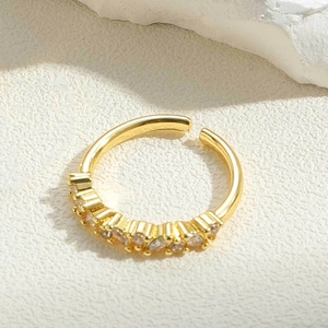 Detailed close-up of golden adjustable ring with seven sparkling cubic zirconia stones