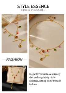 Detail of Y-shaped gold necklace with colorful zircon heart and drop charms on stone