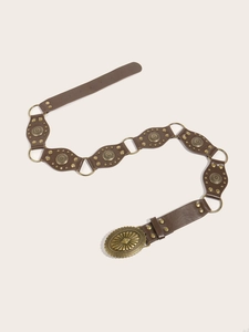 Detailed view of a vintage brown PU leather belt with embossed bronze buckle and studs