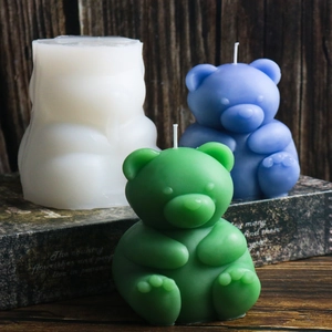 Detail view of 3D bear candle silicone mold and finished handmade wax bear figurines