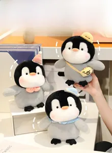Three cute stuffed penguin plush toys in various hats displayed as desk accessories
