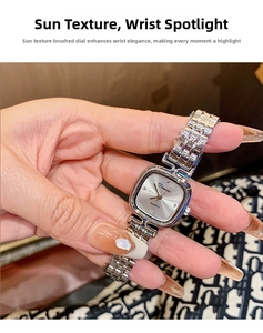 Close-up of square silver quartz watch featuring sunray brushed dial and metal link strap