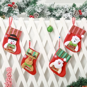 Mini Christmas stockings with 3D Santa and Reindeer hanging on a white wooden fence