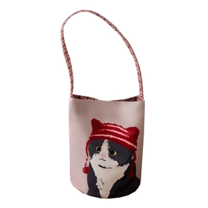 Pink cylinder bucket bag with cartoon cat pattern and red checkered strap details