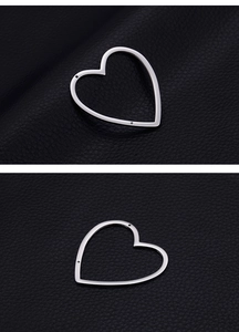 Detailed close-up of polished heart-shaped silver metal frame for DIY jewelry making