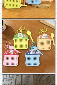 Detail view of four colorful rabbit magnetic bead drawing board keychains on a desk.