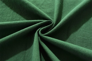 Detailed macro view showing the natural texture and wrinkles of green washed cotton fabric