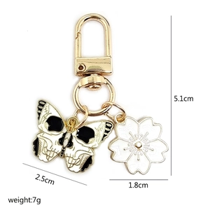 Detail view of butterfly and cherry blossom keychain with size and weight measurements