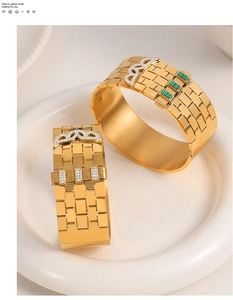 Detail of gold watchband-style bangles with brick texture and turquoise accents
