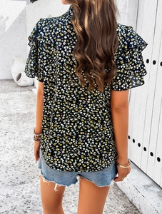Back view of elegant black floral blouse featuring layered ruffle sleeves and high collar
