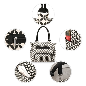 Detail showing diaper bag with geometric pattern, front zipper pocket and metal hardware