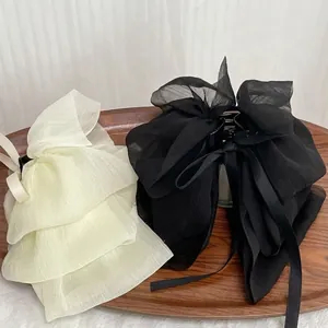 French chiffon bow hair claw clips in cream and black showing light pleated texture