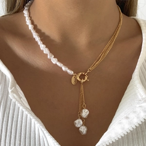 Baroque pearl necklace with asymmetric gold chains and elegant tassel detail for women