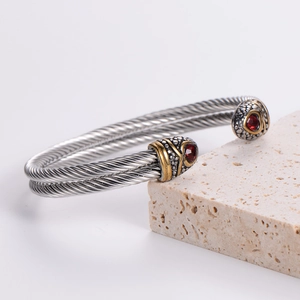 Men's double twisted steel cable cuff bracelet with gold accents and red gemstones