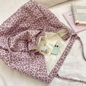 Macro shot of pink leopard print tote bag interior with zipper pocket and magnetic closure