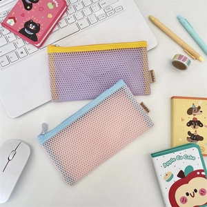 Two-piece set of mesh pencil cases with colorful contrast zippers on a desk setup
