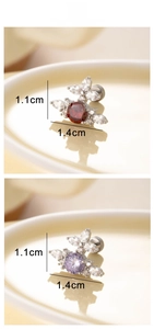 Macro detail of cross flower earrings with red and purple cubic zirconia stones