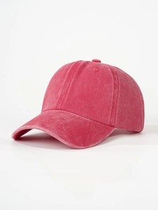 Close-up of rose red washed cotton baseball cap with vintage texture and stitched eyelets