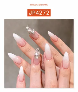 Detail of pink and white gradient press-on nails with luxury rhinestones and almond shape