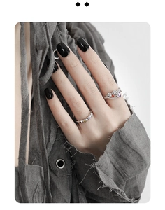 Detail of s925 silver chain rings set with colorful zircons on a model hand