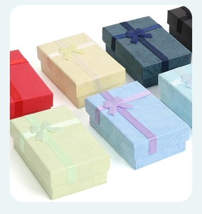 Multi-colored jewelry gift boxes with elegant ribbon bows in a neat diagonal layout