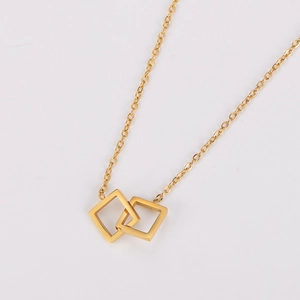 Detail shot of interlocking gold square pendants on a sleek stainless steel chain