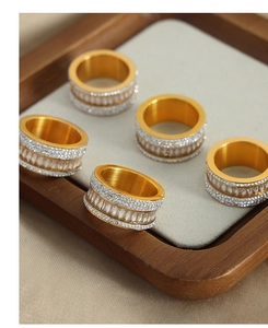 Detailed macro view of 5-piece gold eternity rings set with rectangle and round cubic zirconia