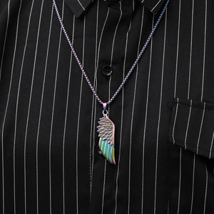 Detailed close-up of rainbow-colored feather wing pendant on a stylish metal chain necklace