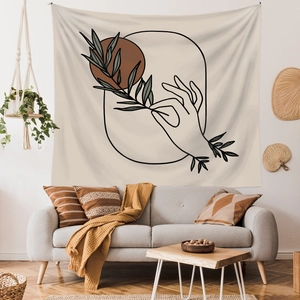 Bohemian minimalist tapestry with line art and plant design over a modern living room sofa