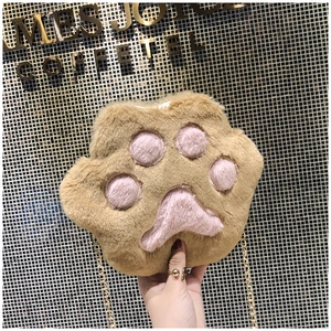 Detail of plush cat paw crossbody bag with pink pads and gold chain strap
