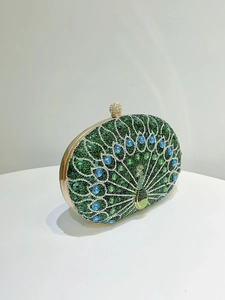 Detailed view of peacock rhinestone clutch bag with sparkling green and blue gemstones