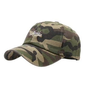 Camo baseball cap with vintage wash and white Dorte embroidery shown at a 45-degree angle